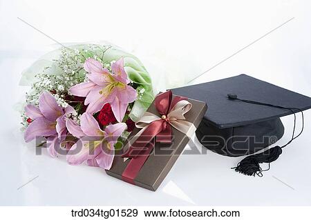 The bouquet of flower, gift, and graduation cap View Large Photo Image Stock Photo - The bouquet of flower, gift, and graduation cap . Fotosearch