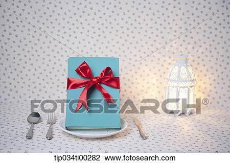 The decorated blue book on the dish, and the light View Large Photo Image Stock Image - The decorated blue book on the dish, and the light . Fotosearch