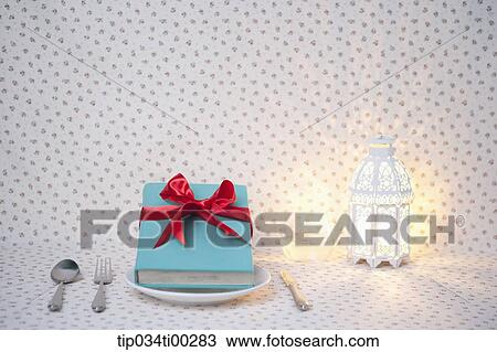 The decorated blue book on the dish, and the light View Large Photo Image Stock Image - The decorated blue book on the dish, and the light . Fotosearch