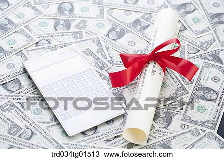 The diploma and calculator on the money View Large Photo Image Stock Image - The diploma and calculator on the money . Fotosearch