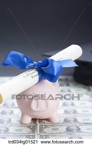 The diploma and piggy bank on the money View Large Photo Image Stock Image - The diploma and piggy bank on the money . Fotosearch
