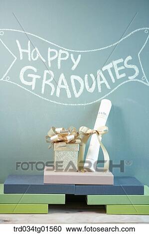 Stock Image - The gift, diploma, books and the celebrating word. Fotosearch