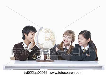 Stock Image - The global students looking at the globe. Fotosearch