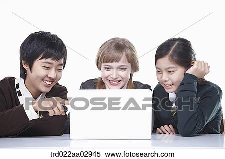 Stock Photography - The global students looking at the laptop . Fotosearch