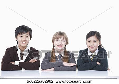 Stock Image - The global students resting their arms on the desk. Fotosearch
