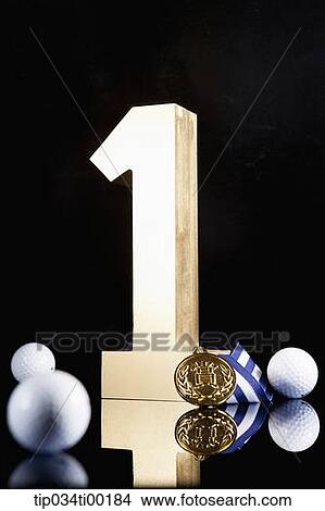 The golden number one, golf ball, and prize medal View Large Photo Image Picture - The golden number one, golf ball, and prize medal. Fotosearch