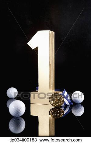 The golden number one, golf ball, and prize medal View Large Photo Image Stock Image - The golden number one, golf ball, and prize medal. Fotosearch