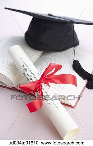 The graduation cap and diploma on the book View Large Photo Image Stock Image - The graduation cap and diploma on the book. Fotosearch