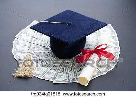 Stock Photography - The graduation cap and diploma on the money . Fotosearch