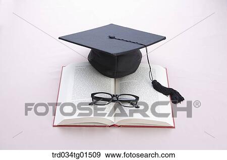 The graduation cap and glasses on the book View Large Photo Image Stock Photo - The graduation cap and glasses on the book. Fotosearch