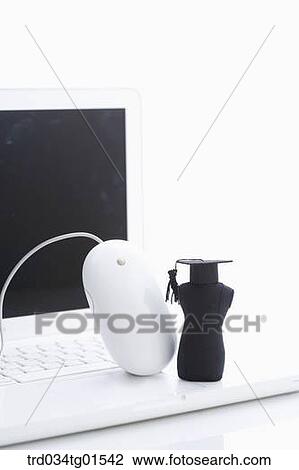 The graduation cap and mouse on the laptop View Large Photo Image Stock Image - The graduation cap and mouse on the laptop . Fotosearch