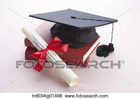 Stock Photo - The graduation cap, the diploma, and the books. Fotosearch