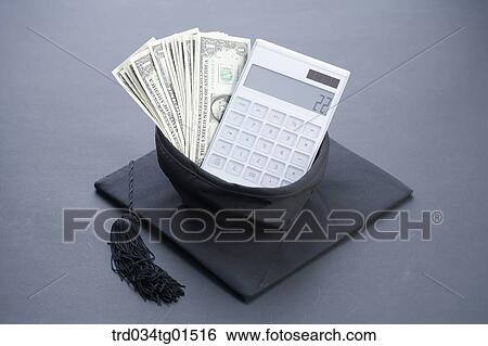 Stock Photograph - The money and calculator in the graduation cap . Fotosearch