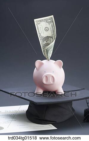 Stock Photo - The money and piggy bank on the graduation cap . Fotosearch