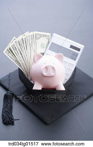 The money, calculator, and piggy bank in the graduation cap View Large Photo Image Stock Photo - The money, calculator, and piggy bank in the graduation cap . Fotosearch