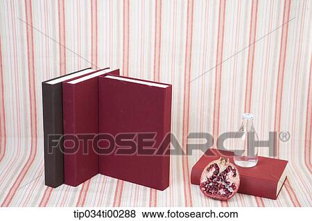 The red and brown cover book, glass bottle, and pomegranate View Large Photo Image Stock Photo - The red and brown cover book, glass bottle, and pomegranate . Fotosearch