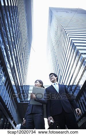A business man and a business woman watching in the same direction View Large Photo Image Picture - A business man and a business woman watching in the same direction. Fotosearch