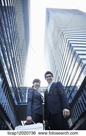A business man and a business woman watching down towards the camera View Large Photo Image Stock Photograph - A business man and a business woman watching down towards the camera. Fotosearch