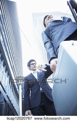 A business man checking the time on his watch View Large Photo Image Stock Photo - A business man checking the time on his watch. Fotosearch