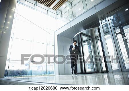 A business man with a briefcase man running checking the time on his watch View Large Photo Image Stock Image - A business man with a briefcase man running checking the time on his watch. Fotosearch