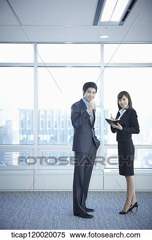 Stock Photography - A business woman and a man in their break time. Fotosearch