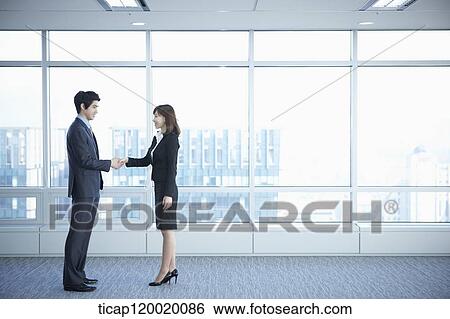 A business woman and a man shaking hands View Large Photo Image Stock Photograph - A business woman and a man shaking hands. Fotosearch