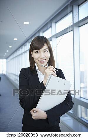 A business woman smiling with a folder in her arms View Large Photo Image Stock Image - A business woman smiling with a folder in her arms. Fotosearch