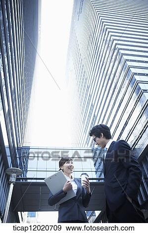 A business woman with paperfiles and a coffee cup having a discussion View Large Photo Image Stock Photo - A business woman with paperfiles and a coffee cup having a discussion . Fotosearch
