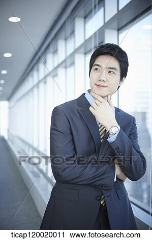A businessman looking at his schedule book View Large Photo Image Stock Image - A businessman looking at his schedule book. Fotosearch