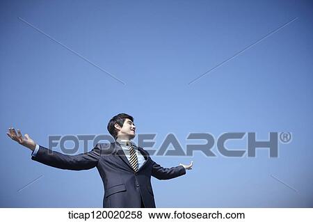 A businessman spreading arms wide View Large Photo Image Stock Photo - A businessman spreading arms wide. Fotosearch
