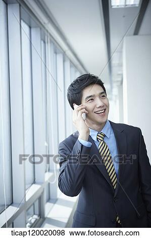 A businessman talking on a phone View Large Photo Image Stock Photo - A businessman talking on a phone . Fotosearch