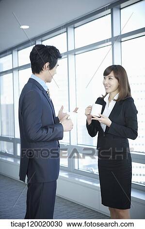 A businessman talking with a business woman View Large Photo Image Stock Image - A businessman talking with a business woman. Fotosearch