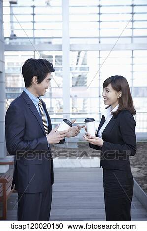 A businesswoman and businessman having a coffee while discussing View Large Photo Image Stock Image - A businesswoman and businessman having a coffee while discussing. Fotosearch