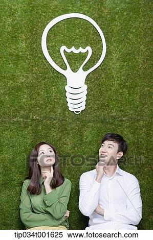 a couple coming up with idea together under the bulb View Large Photo Image Stock Photography - a couple coming up with idea together under the bulb. Fotosearch