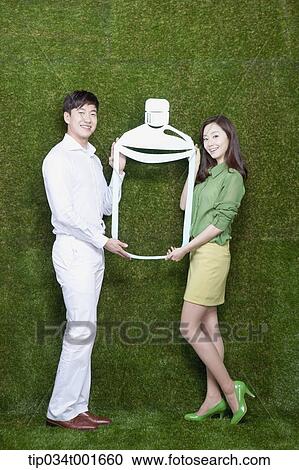a couple holding a bottle with their hands View Large Photo Image Stock Image - a couple holding a bottle with their hands. Fotosearch