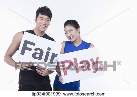 a couple of athletes holding a placard of Fair Play View Large Photo Image Stock Photo - a couple of athletes holding a placard of Fair Play. Fotosearch