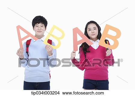 a couple of students holding letters of A and B View Large Photo Image Picture - a couple of students holding letters of A and B. Fotosearch