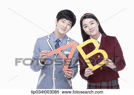 a couple of students holding letters of A and B View Large Photo Image Stock Photography - a couple of students holding letters of A and B. Fotosearch