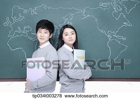 Stock Photo - a couple of students leaning against each other in front of the blackboard. Fotosearch