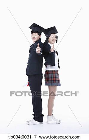 Stock Photo - a couple of students leaning each other and giving thumbs-up. Fotosearch