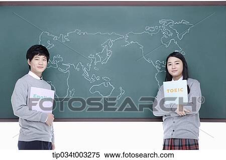 Stock Photography - a couple of students standing in front of the blackboard. Fotosearch