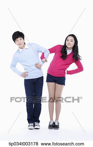 Stock Photo - a couple of students standing with arms akimbo. Fotosearch