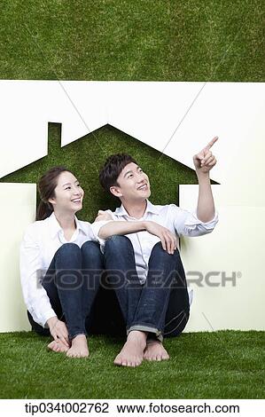 a couple sitting together in the paper house View Large Photo Image Stock Image - a couple sitting together in the paper house. Fotosearch