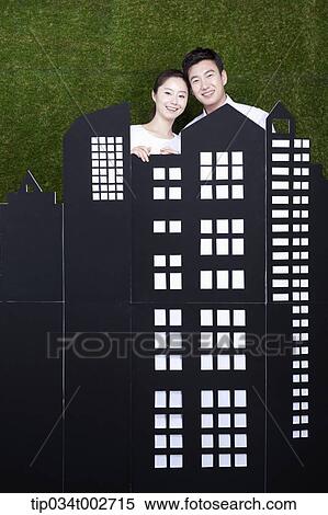 a couple standing behind the building model View Large Photo Image Stock Photography - a couple standing behind the building model . Fotosearch