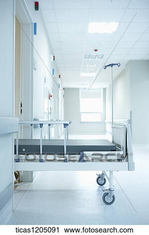 A empty hospital bed half way out of a room View Large Photo Image Stock Image - A empty hospital bed half way out of a room. Fotosearch