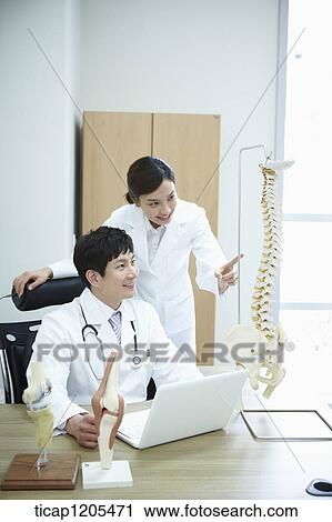 A female surgeon pointing at a spine model in a male surgeon's offcie View Large Photo Image Stock Image - A female surgeon pointing at a spine model in a male surgeon's offcie. Fotosearch