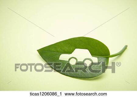 Stock Image - A green leaf with a car logo cut out of it. Fotosearch