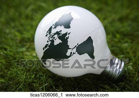 Stock Image - A light bulb of earth placed on grass. Fotosearch