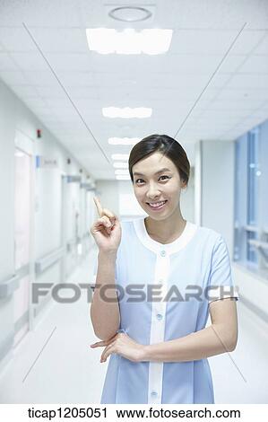 A nurse having an idea in an empty hospital corridor View Large Photo Image Stock Image - A nurse having an idea in an empty hospital corridor. Fotosearch