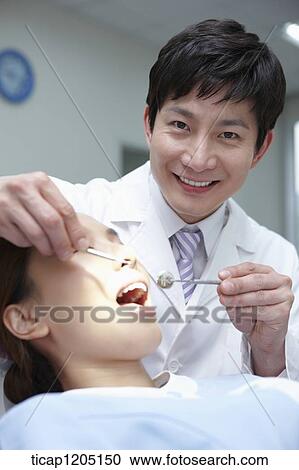 A patient having a dental treatment View Large Photo Image Stock Image - A patient having a dental treatment. Fotosearch